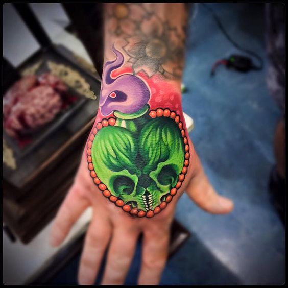 Double Skull Poison hand tattoo