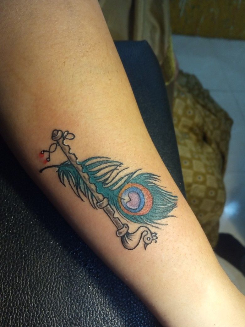 Flute with Peacock Feather Tattoo